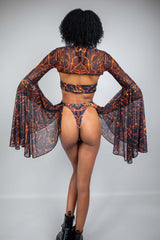 Freedom Rave Wear lava print rave bikini with sheer bell-sleeve top. Back view showcases the fiery design, ideal for making a bold statement