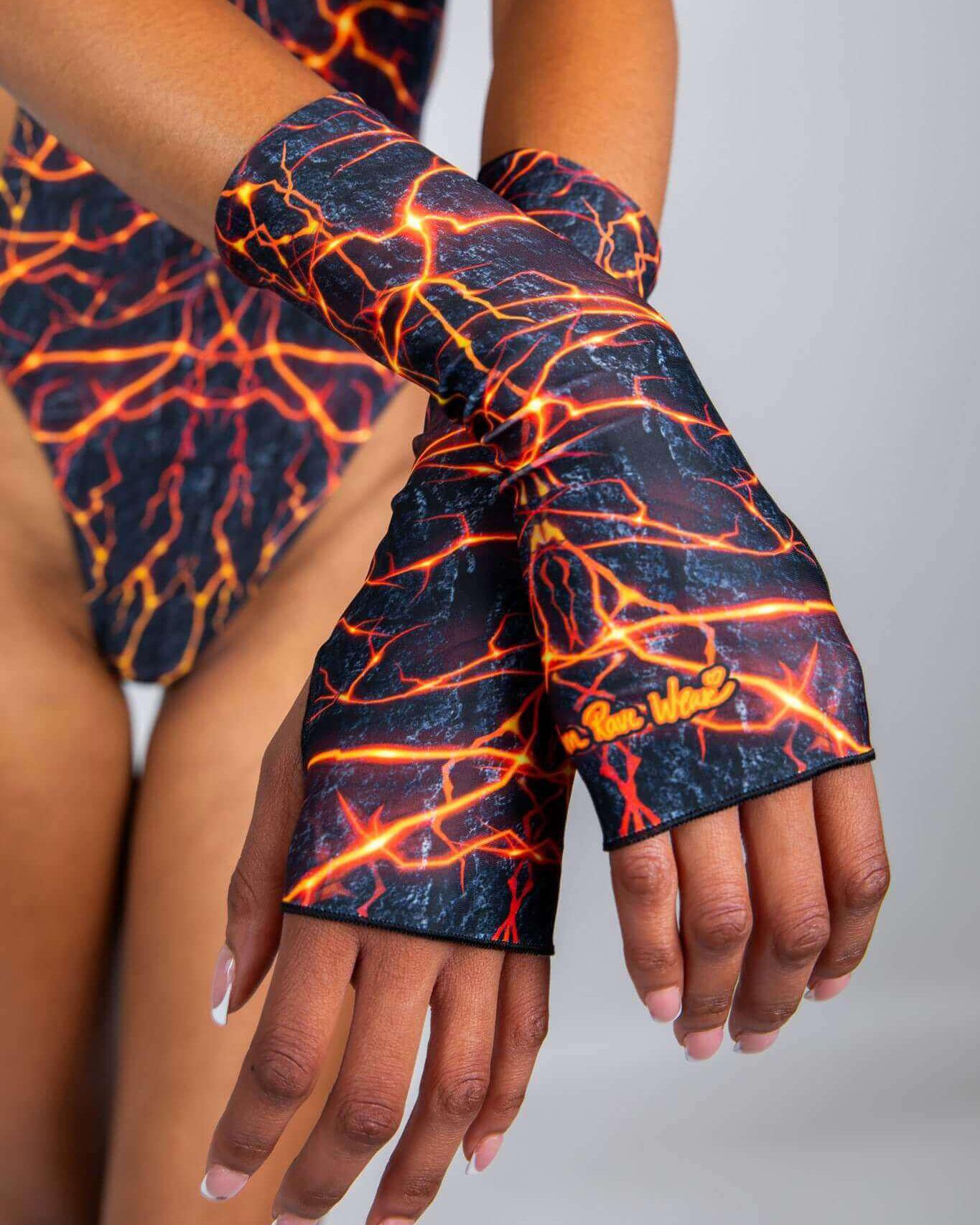 Magma Gloves on model, featuring fiery design perfect for rave outfits, showcasing thumb holes and forearm coverage.