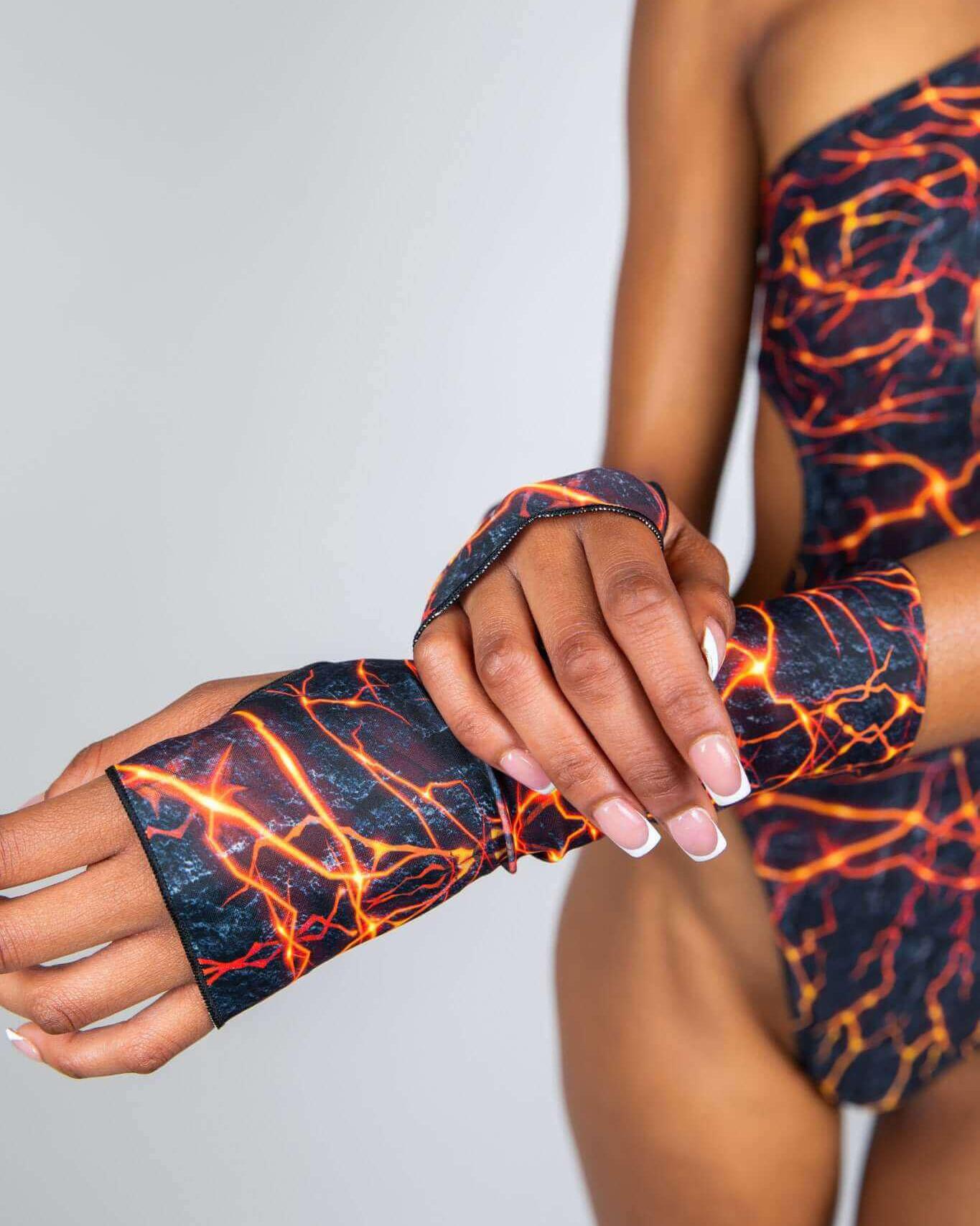 Magma Gloves with fiery pattern worn by model, showcasing a stylish rave outfit perfect for events.