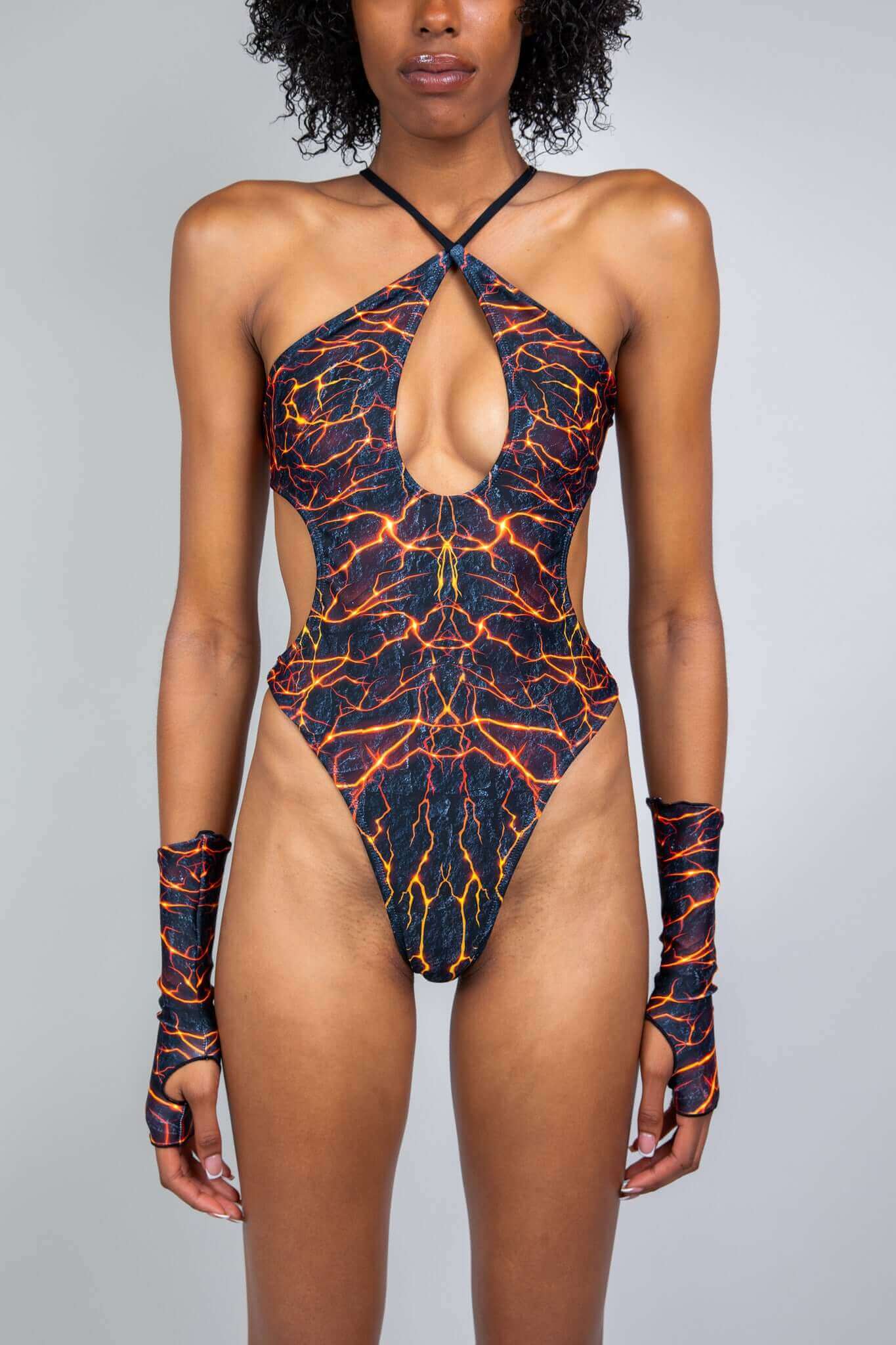 Model in Freedom Rave Wear's lightning print rave bodysuit with a keyhole neckline and matching fingerless gloves.