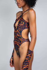 Side view of a model in Freedom Rave Wear's lightning print rave bodysuit featuring cut-out sides and matching fingerless gloves.