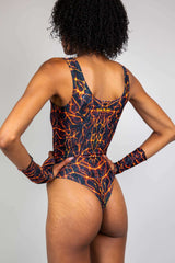 Model wearing Magma High Neck Bodysuit with fiery lava design, perfect for rave outfits and dance floor style.