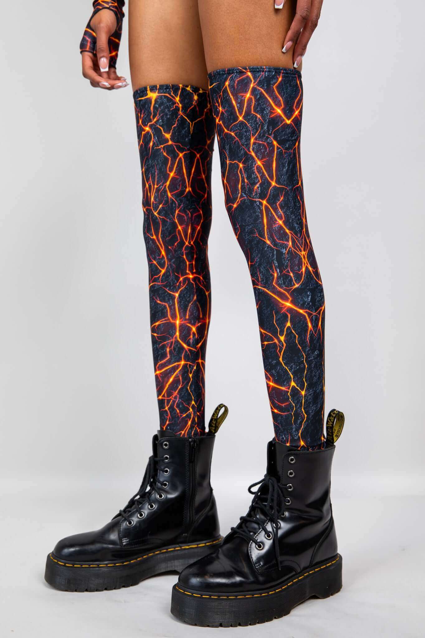 Freedom Rave Wear lightning print thigh-high boot covers and matching arm warmers, paired with black combat boots, embody rave style.