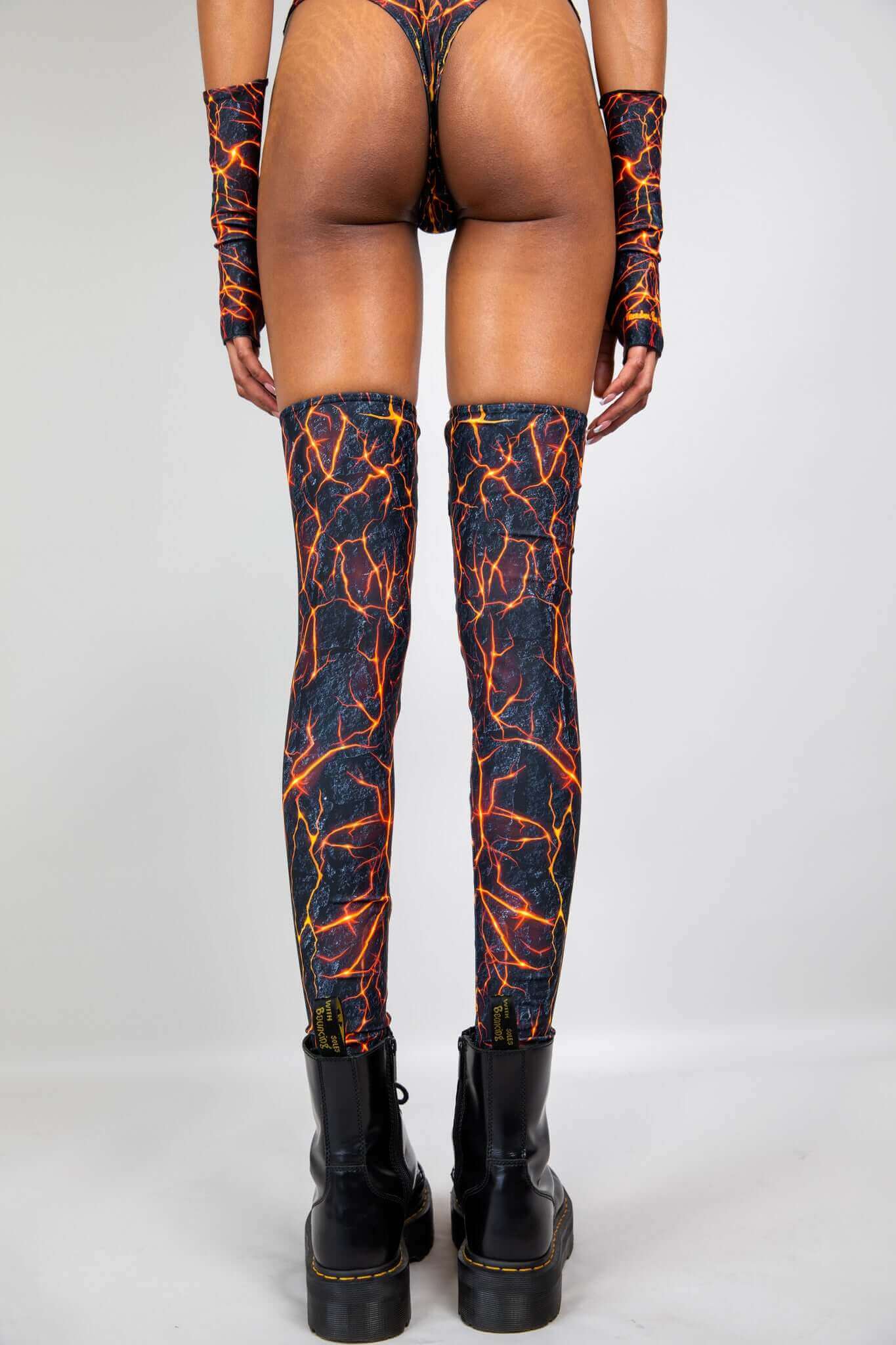 Freedom Rave Wear lightning print thigh-high boot covers and arm warmers, shown from the back, paired with black combat boots for a rave look.