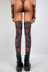 Freedom Rave Wear lightning print thigh-high boot covers and arm warmers, shown from the back, paired with black combat boots for a rave look.