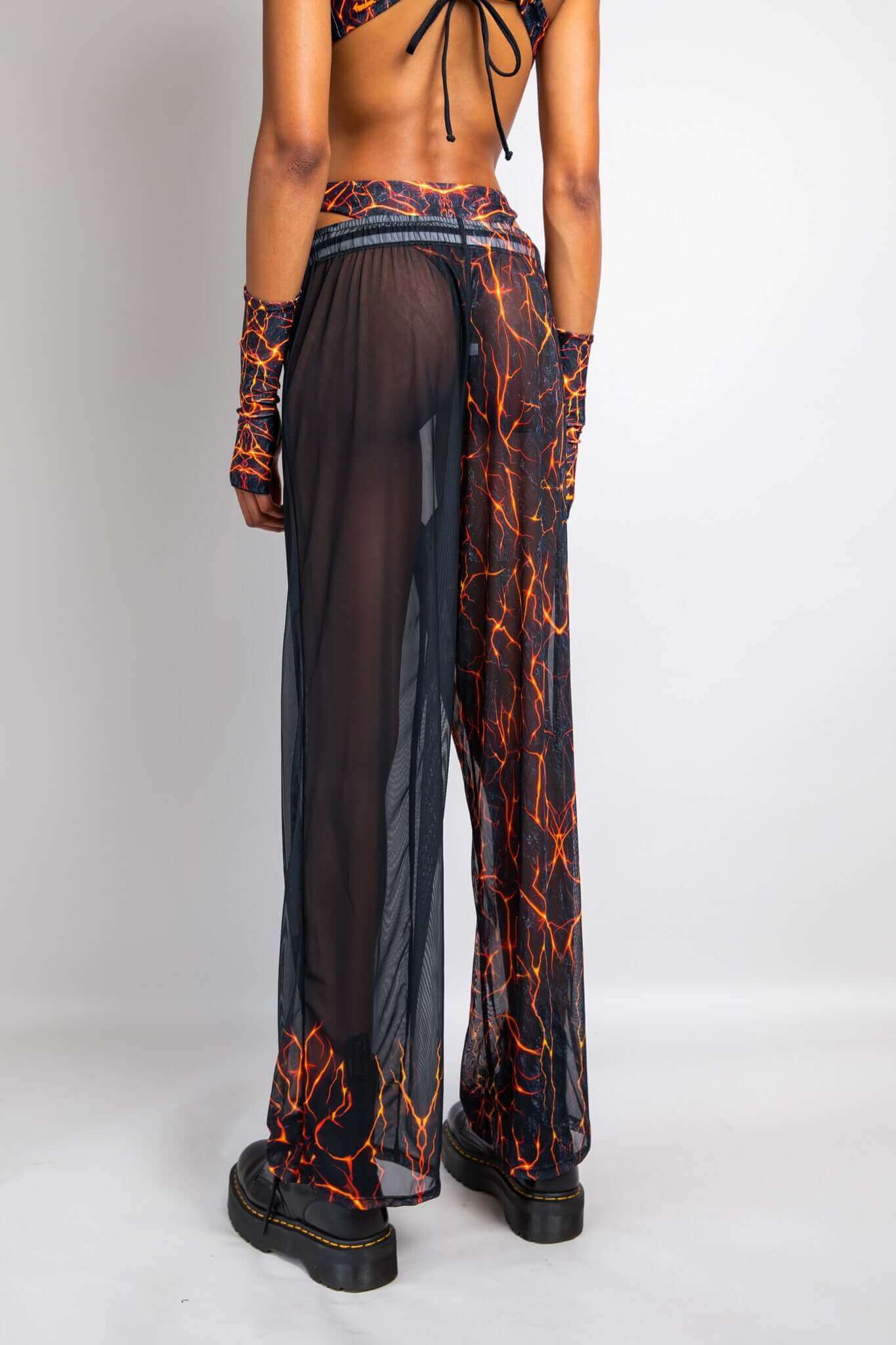 Freedom Rave Wear sheer pants with lava print, featuring side slits and matching arm sleeves. Perfect for making a statement at any rave.