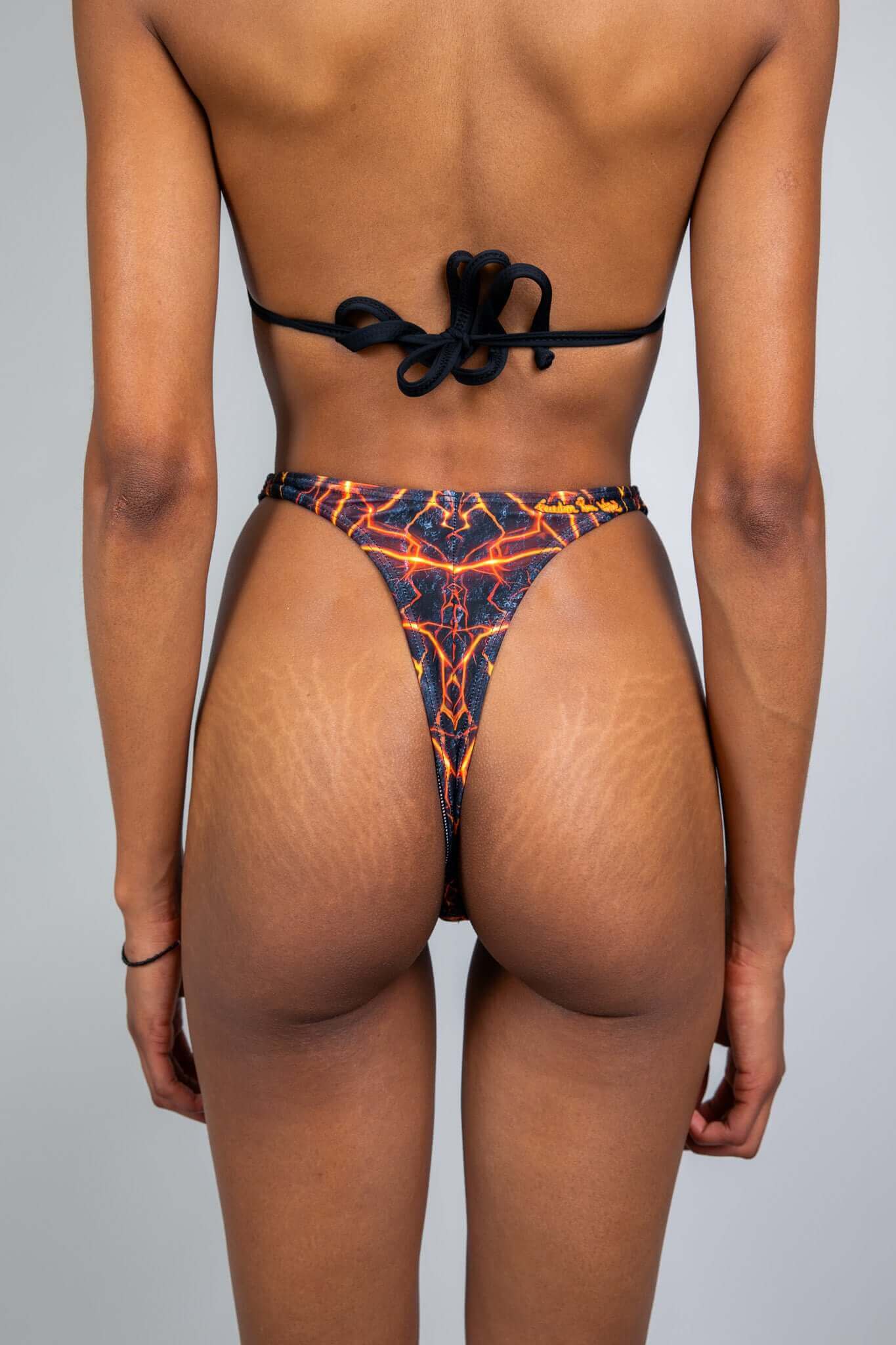 Freedom Rave Wear bikini bottom with high-cut design and bold lava print. Perfect for standing out at any festival or rave event.