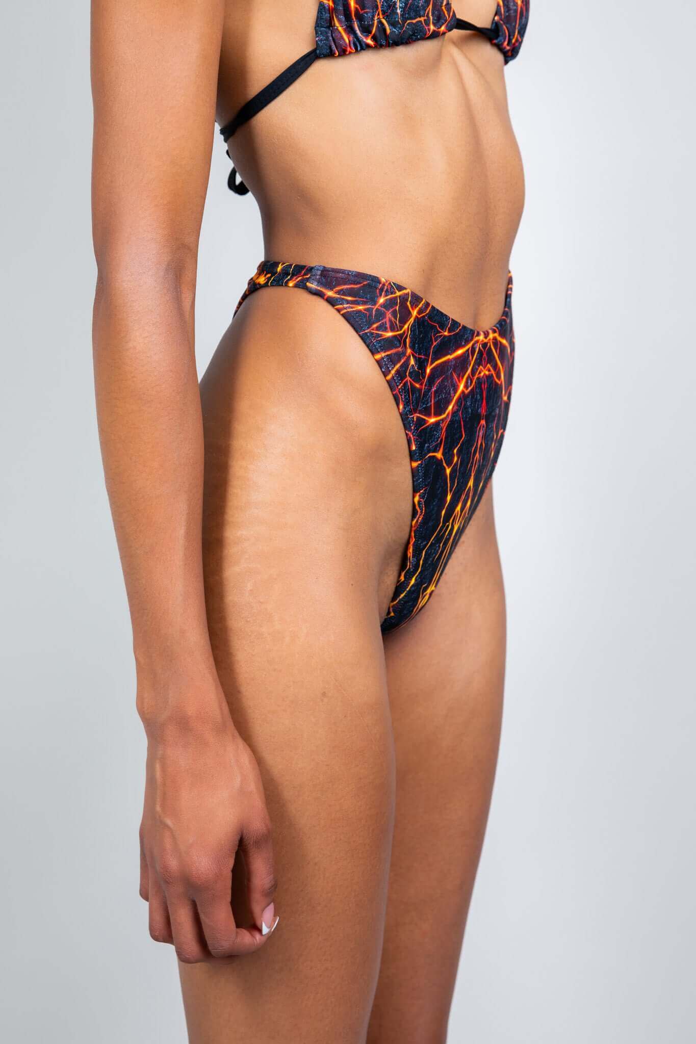 Freedom Rave Wear bikini bottom with a high-cut design and striking lava print, perfect for standout rave outfits and festival looks.