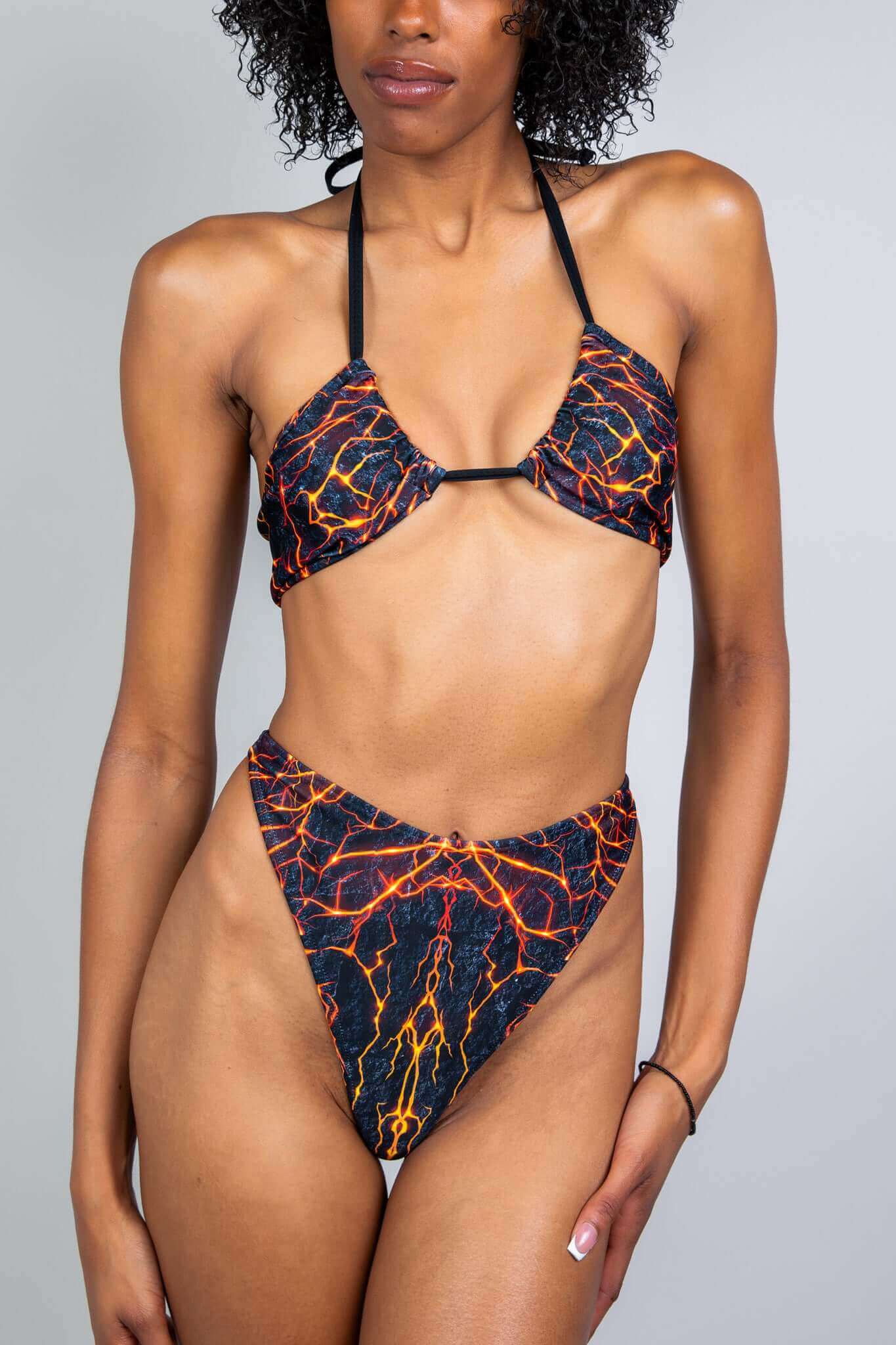 Freedom Rave Wear bikini set with a striking lava print, featuring a triangle top and high-cut bottoms, ideal for making a bold statement at festivals.