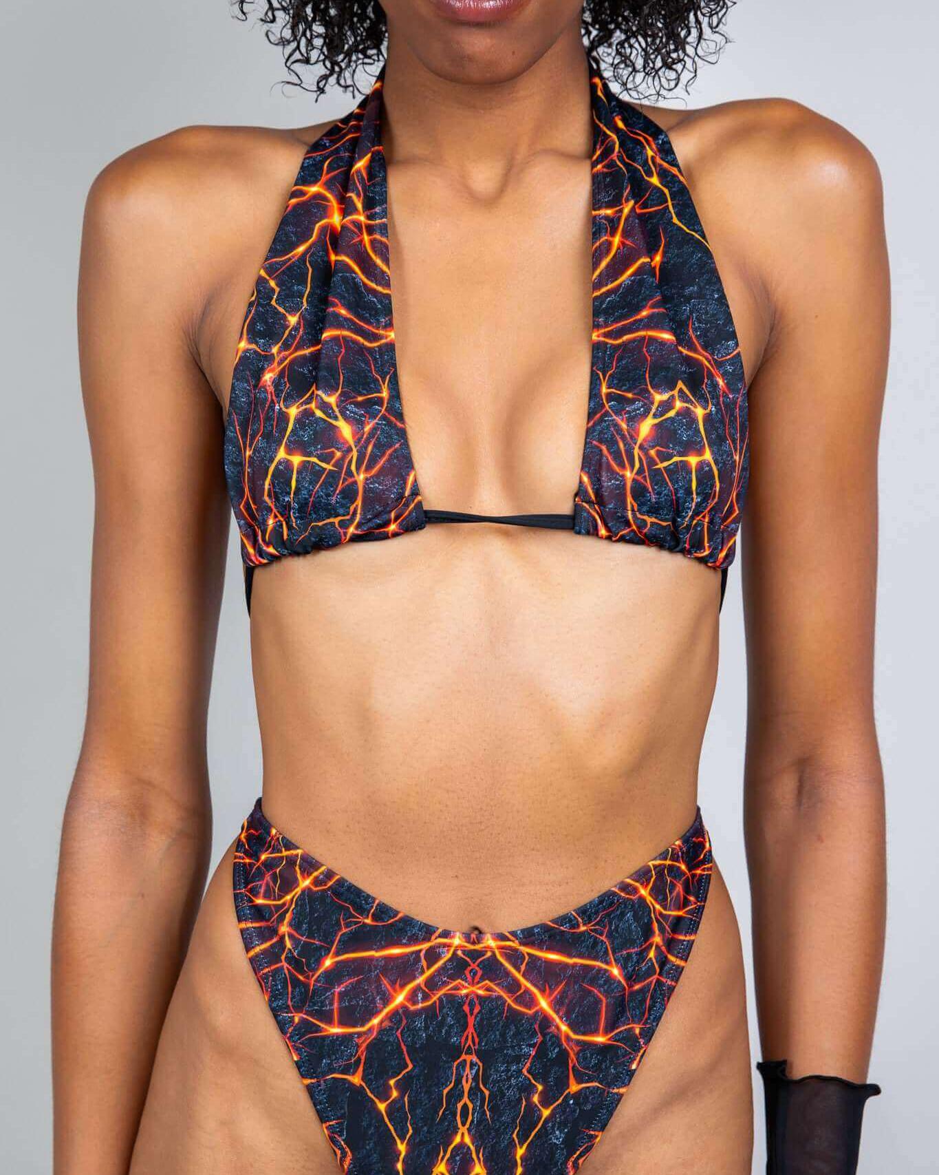 Model showcasing the Magma Twist Tie Bandeau Top with lava-inspired design, perfect for stunning rave outfits.