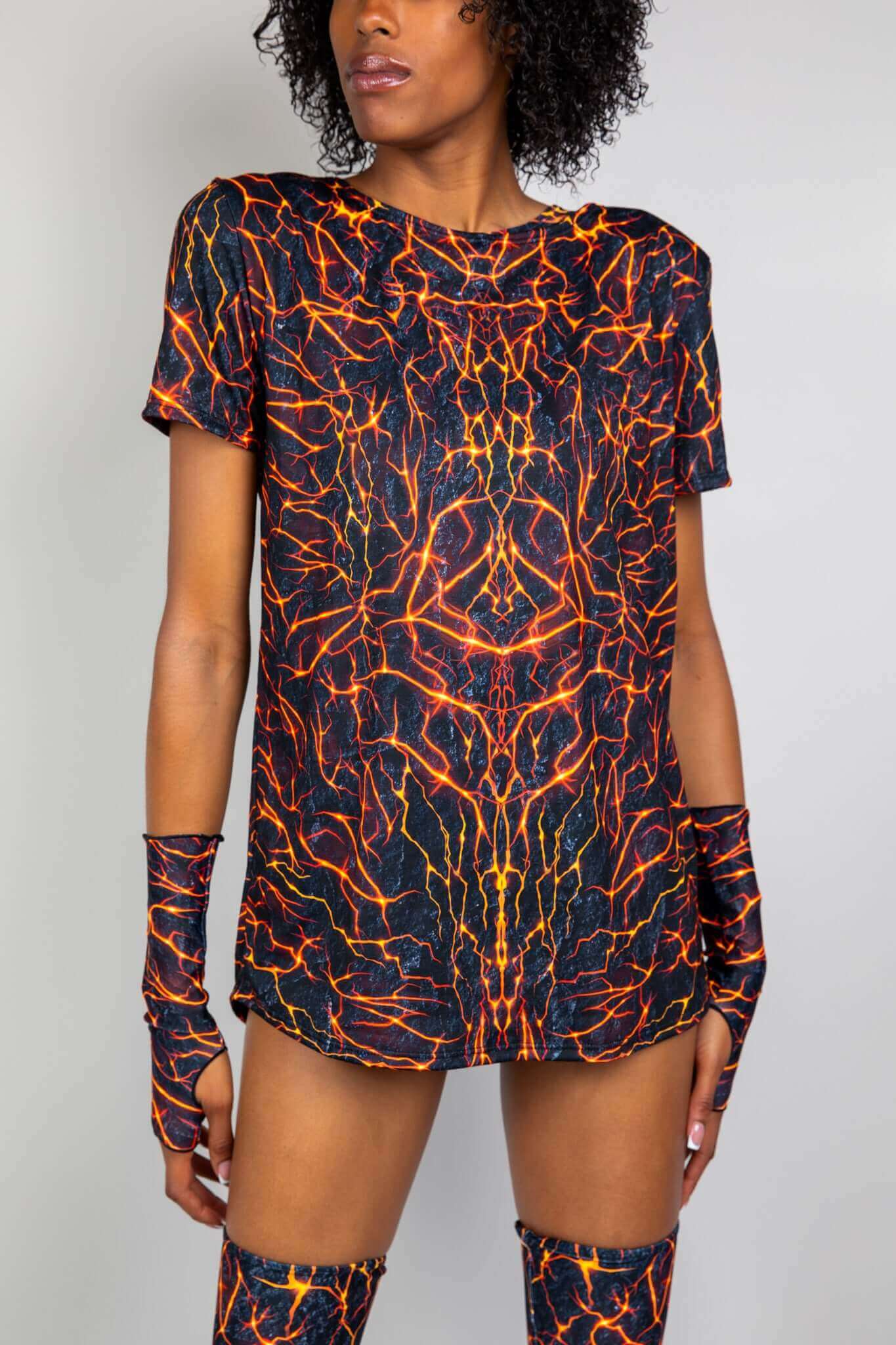 Model in Freedom Rave Wear t-shirt with lava print. Matching arm sleeves and thigh-high accessories. Vibrant and bold design.