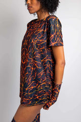 Side view of model in Freedom Rave Wear t-shirt with lava print. Includes matching arm sleeves and vibrant design elements.