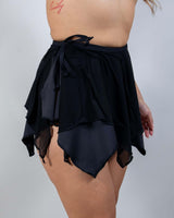 Angled front view of the Matte Black Fairy Skirt featuring a layered, flowy design with a playful hem.