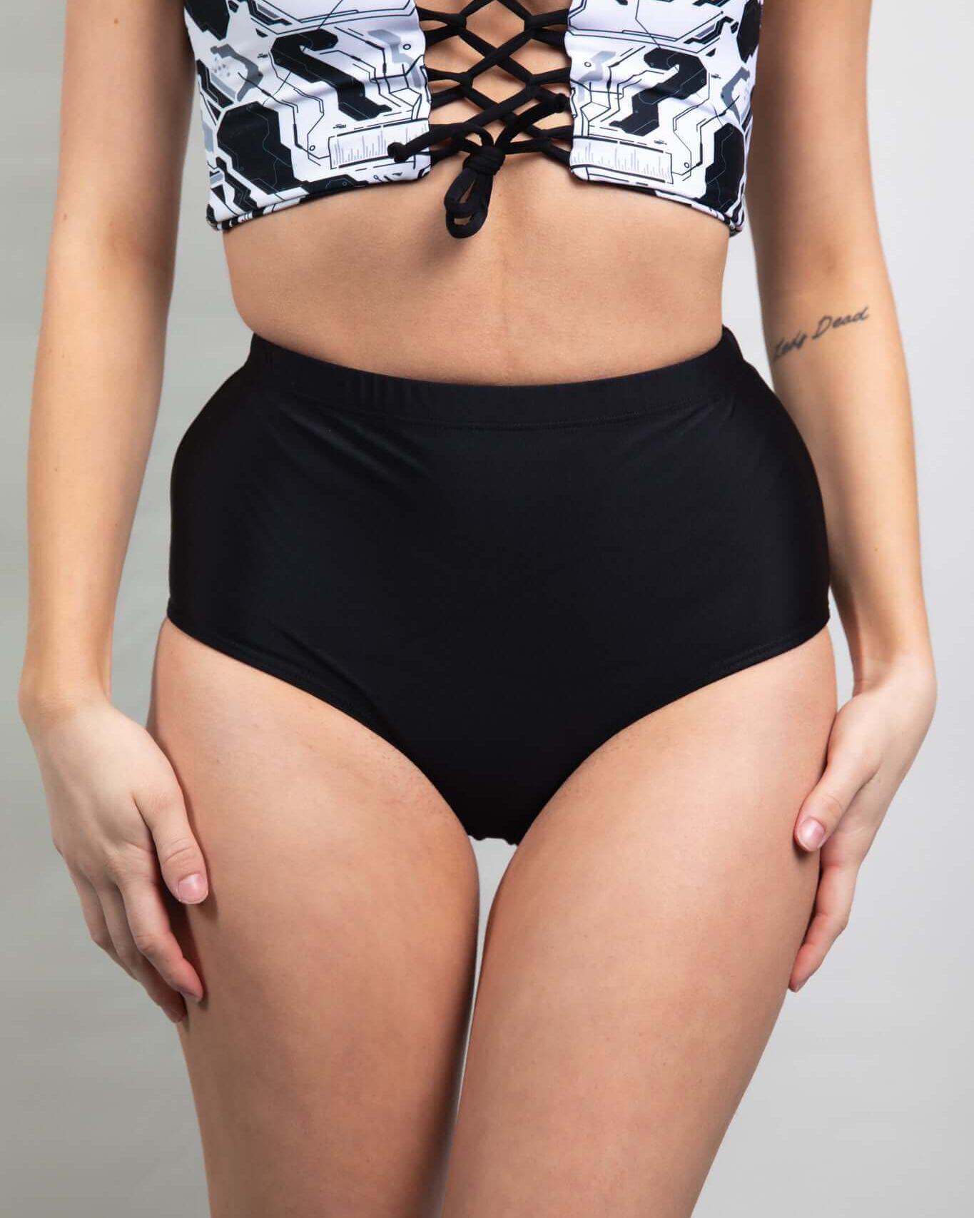 Matte Black high waisted bottoms paired with a stylish lace-up crop top, ideal for chic rave outfits.