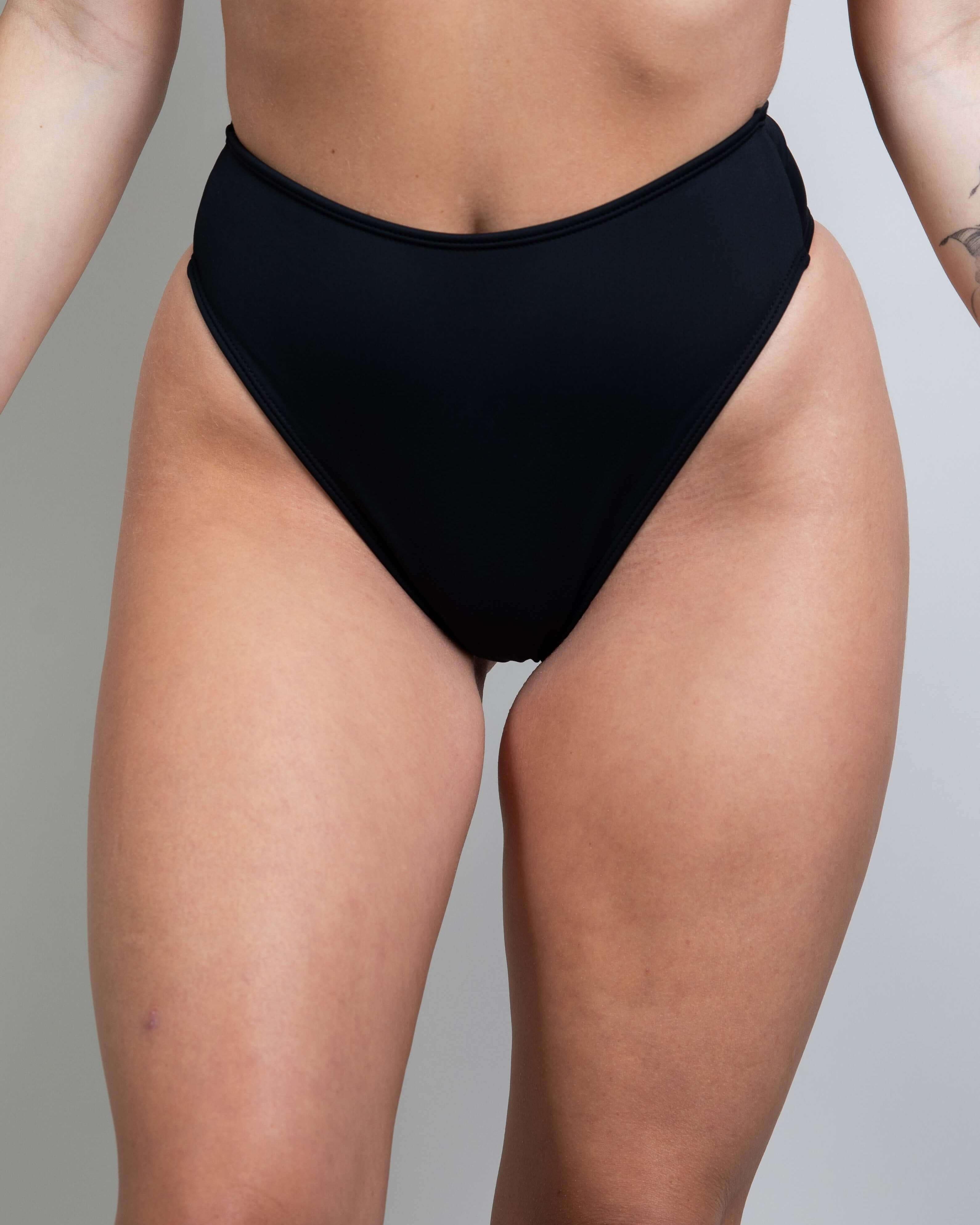 Matte black high waisted thong, perfect for rave outfits, showcasing a cheeky cut and recycled material design.