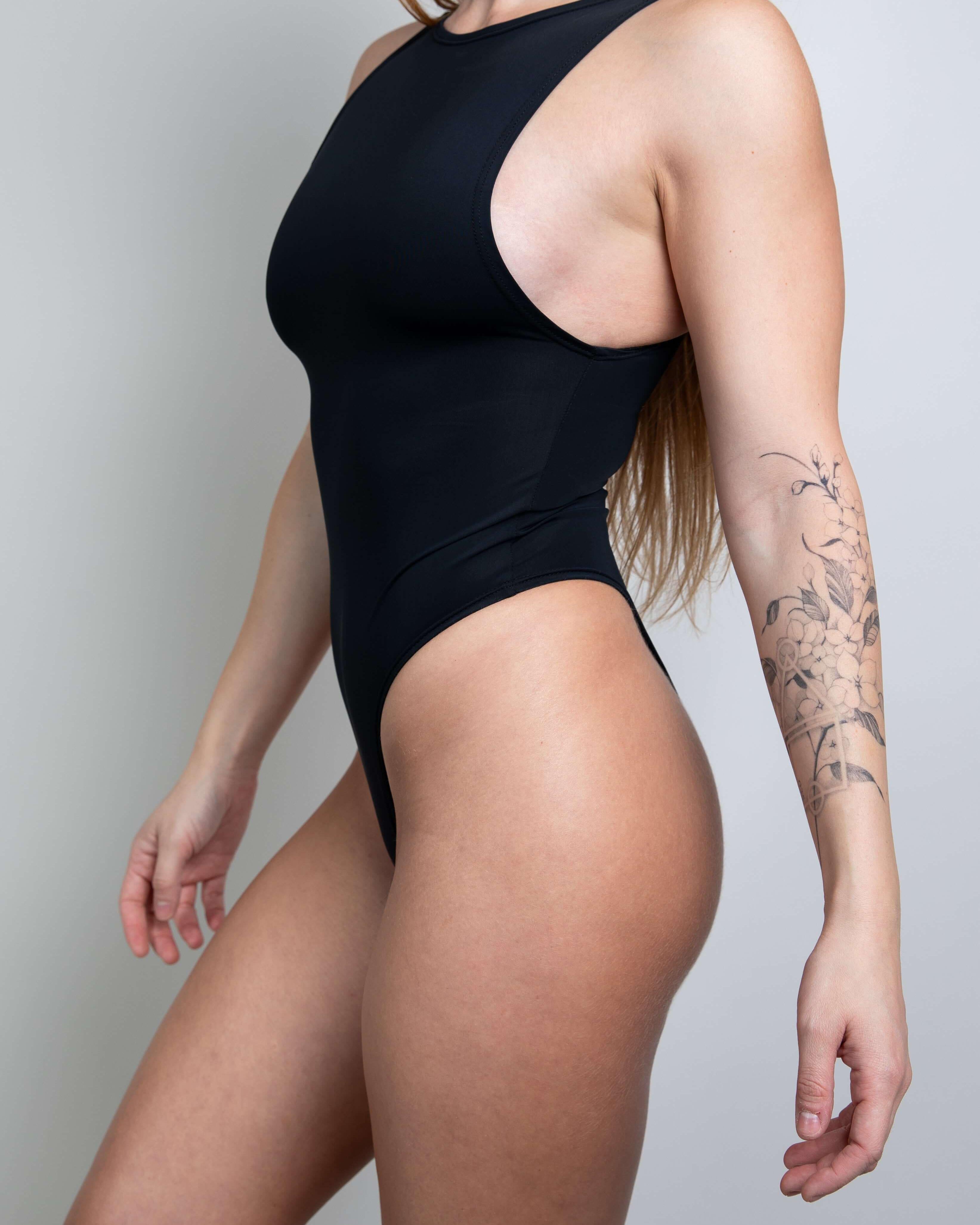 Matte black sideboob bodysuit showcasing high neck design and sustainable material, perfect for rave outfits.