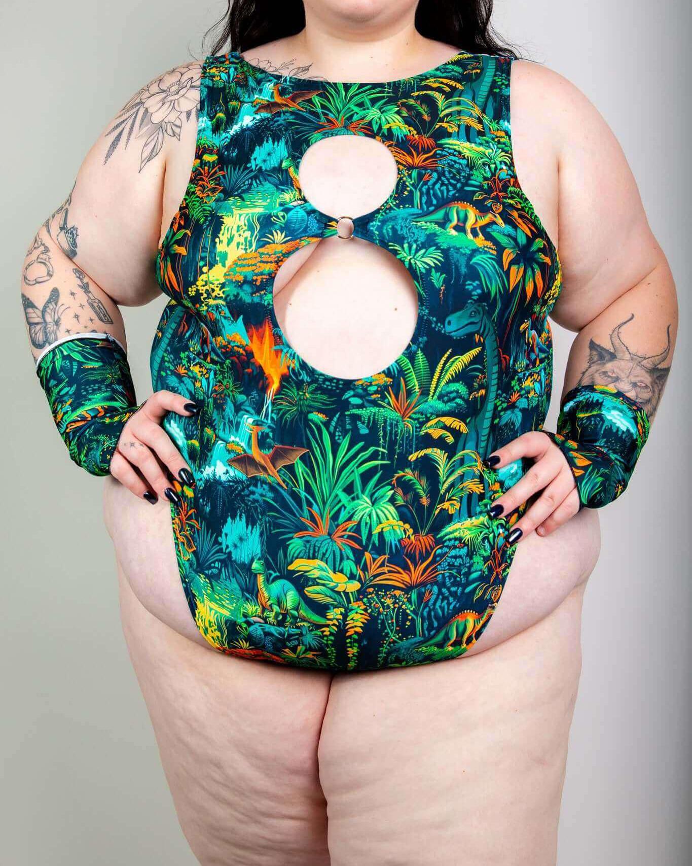 Colorful Mesozoic Keyhole Bodysuit featuring chest cutouts and vibrant jungle design, perfect for rave outfits.