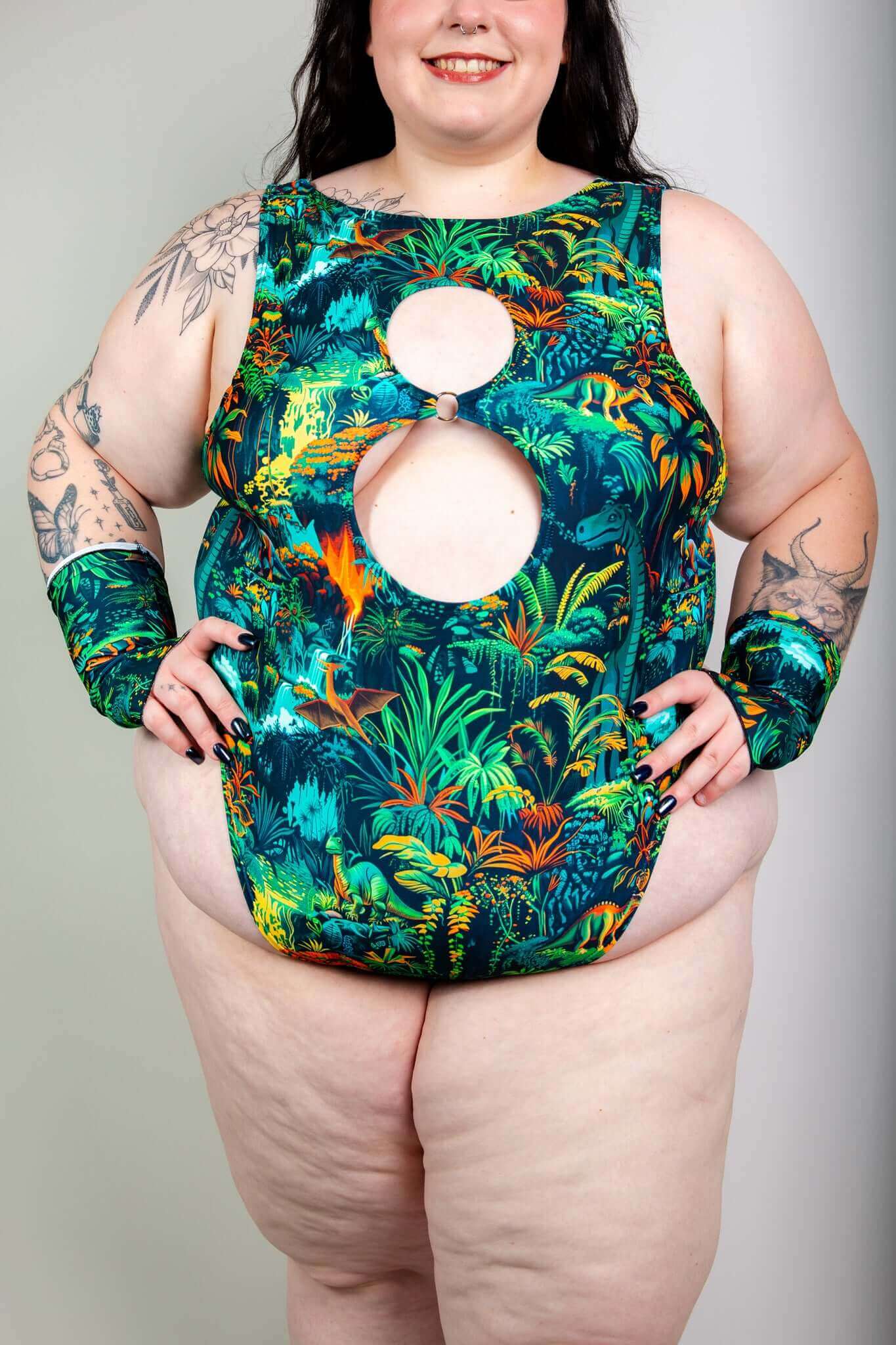 Model wearing Freedom Rave Wear bodysuit with a green dinosaur jungle print, perfect for a bold and stylish rave outfit.