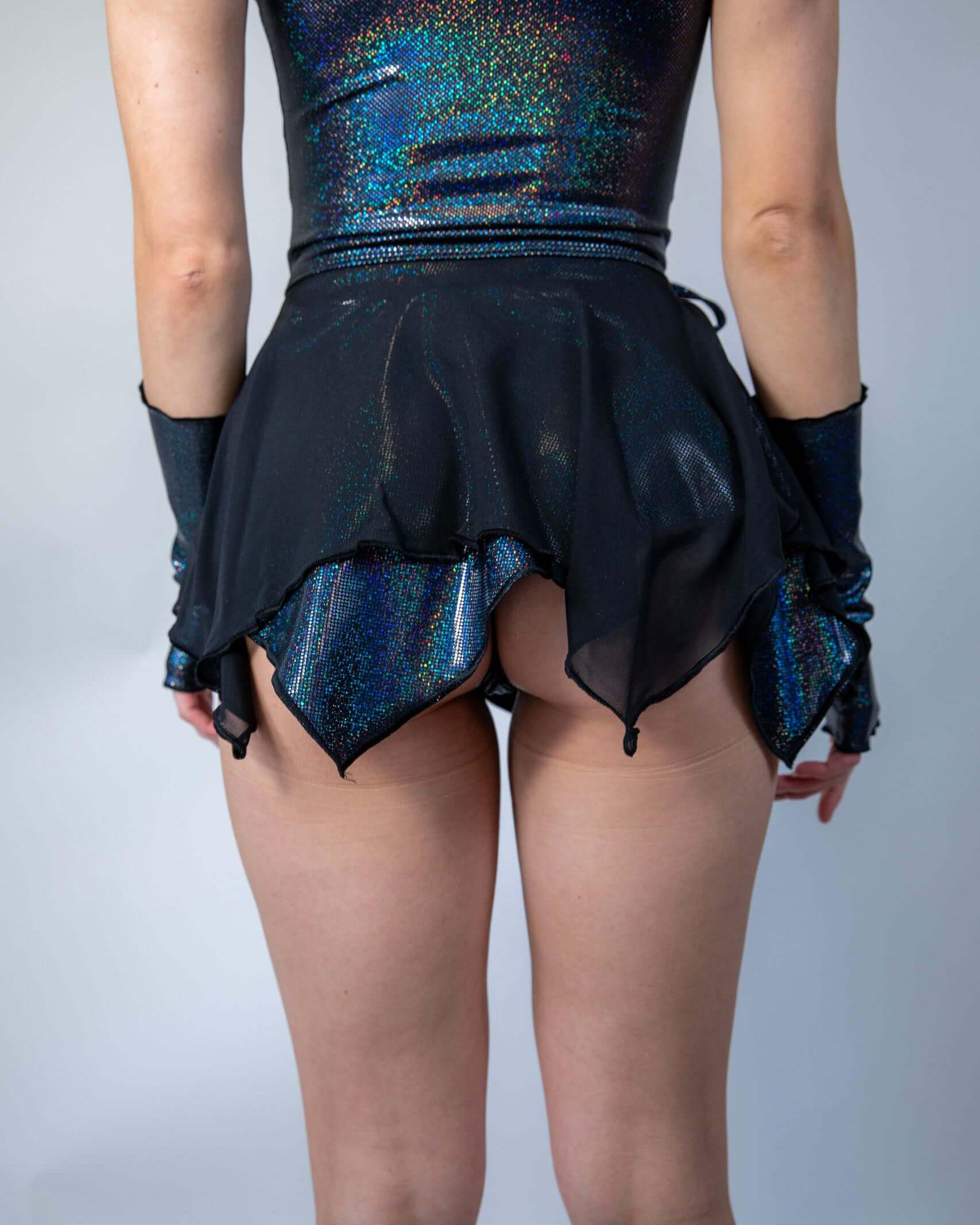 Back view of a model wearing a double-layered black sparkle fairy skirt, perfect for rave outfits and magical looks.