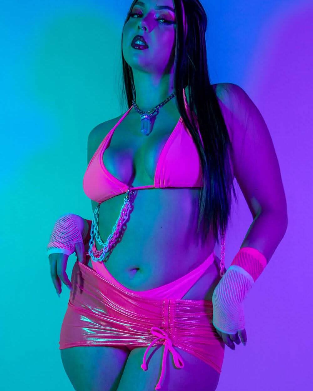 Model showcasing the Peony Bikini Top in neon pink, perfect for rave outfits and vibrant summer style.