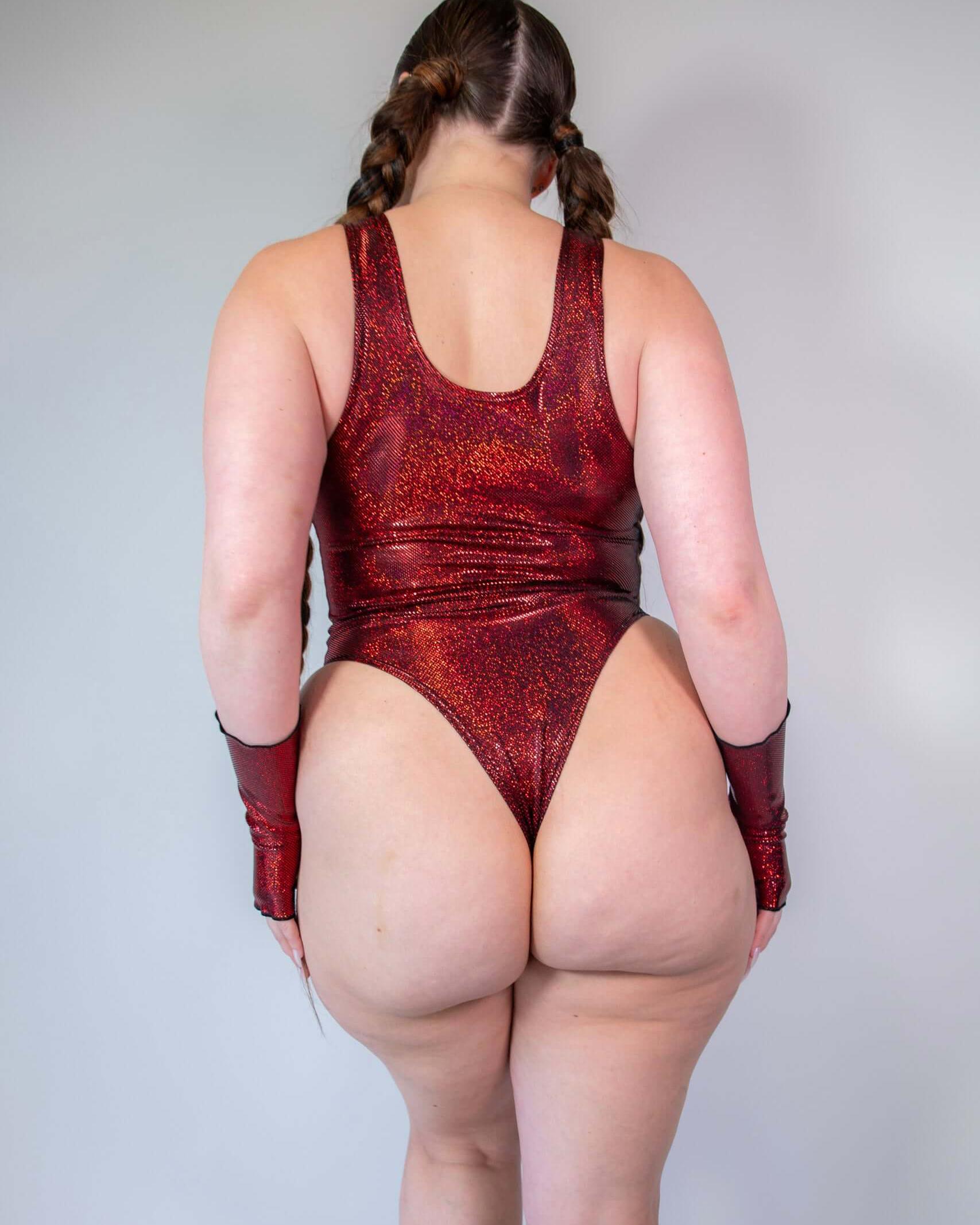 Back view of a model wearing the Phoenix Keyhole Bodysuit in sparkly red, perfect for rave outfits and stylish events.