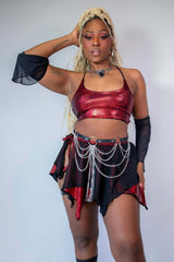 Red sparkly crop top paired with a black skirt featuring chain details, perfect for rave outfits and stylish events.