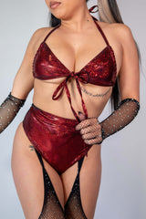 Model wearing the red sparkly Phoenix Wrap Bikini Top, styled for raves with fishnet gloves and high-cut bikini bottoms.