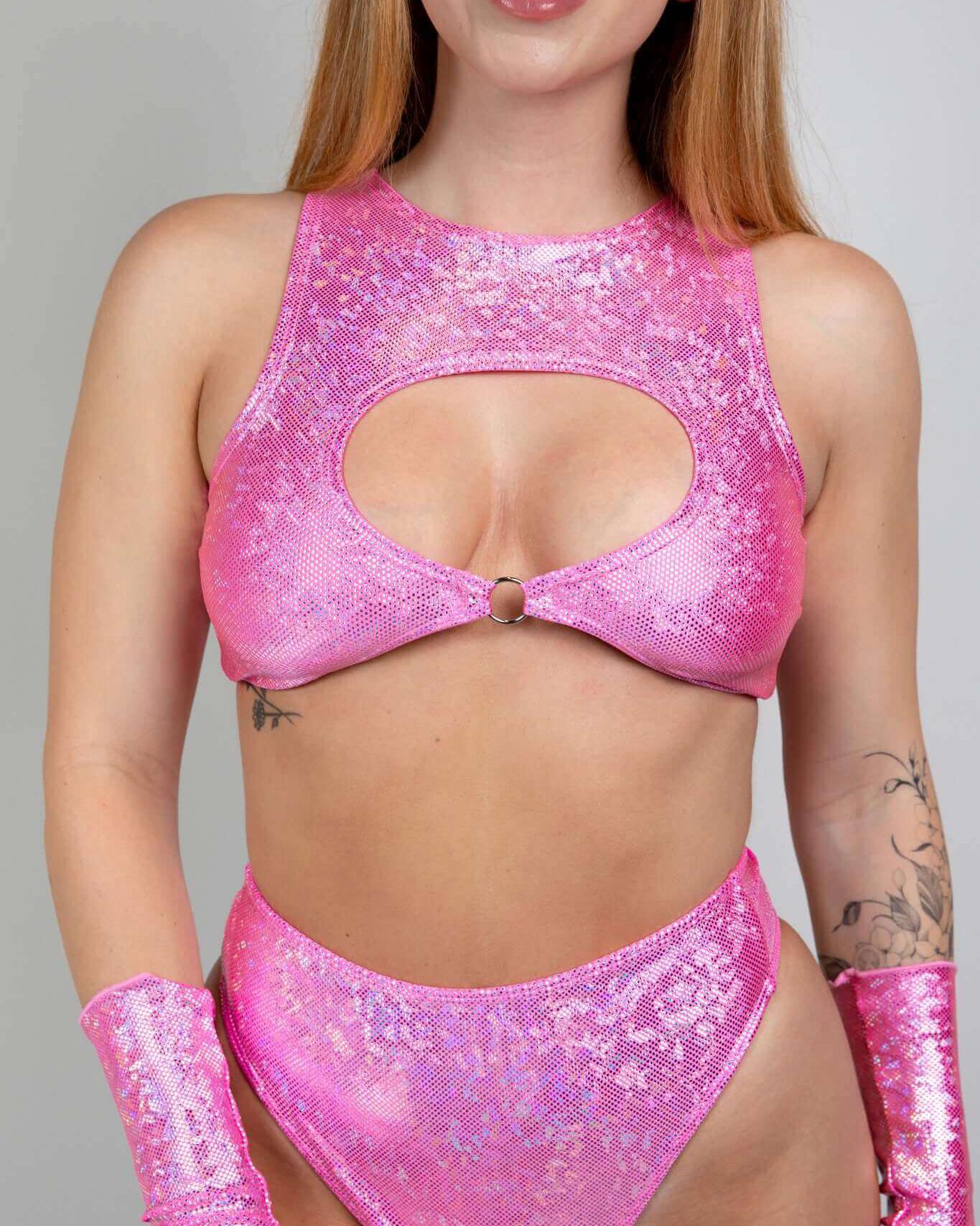 Model showcasing a pink Bubble Gum Holo Keyhole Top with O-ring, perfect for rave outfits and festival fashion.