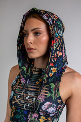 Woman wearing Poison Assassin Hood with bold skull and floral print, perfect for rave outfits and edgy streetwear.