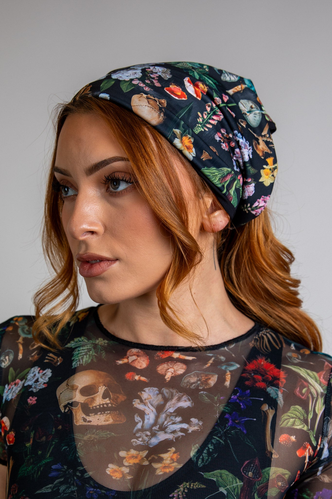 Model wearing Poison Bandana with a vibrant abstract design on black fabric, perfect for rave and festival fashion, side view.