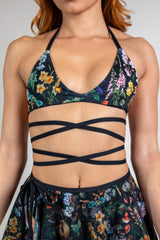 Poison Extra Mile Bralette with bold floral print and wraparound straps, ideal for rave outfits and festivals.