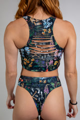 Poison Slit Crop Top showcasing edgy slit details and vibrant floral print, perfect for rave outfits.