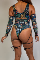 Poison Slit Sideboob Bodysuit with leg straps, featuring a vibrant skull and floral print, perfect for rave outfits.