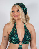 Model wearing the Predator Bandana with a green and black scale print, showcasing a bold rave outfit.