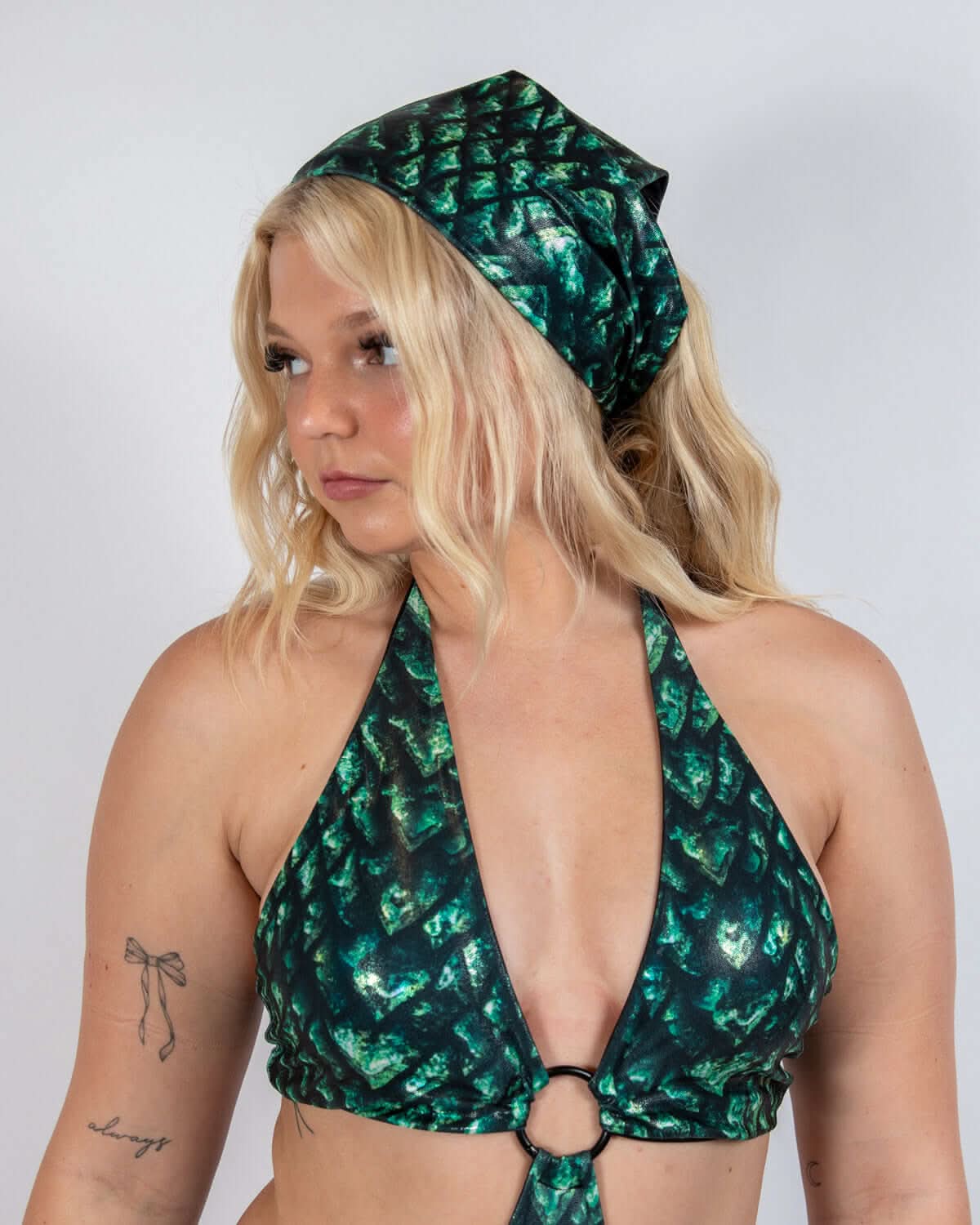 Model wearing a green and black scale print Predator Bandana, perfect for rave outfits and edgy dance floor styles.