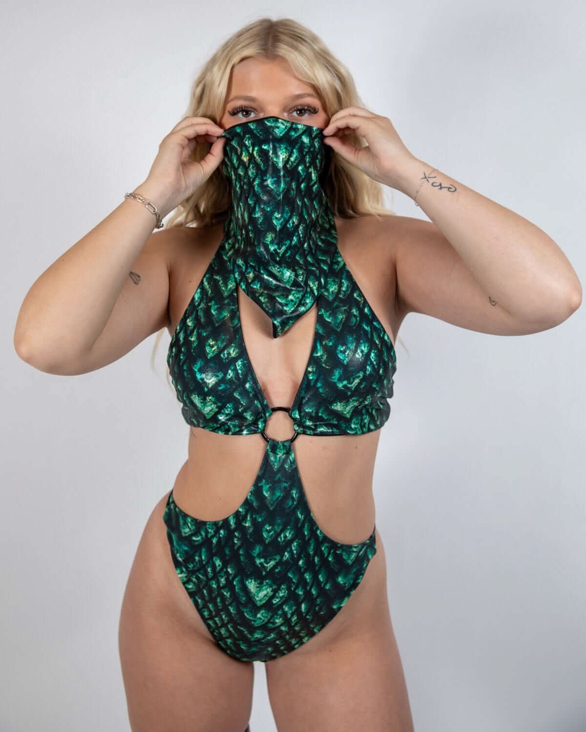 Model showcasing the Predator Bandana in green and black scale print, perfect for rave outfits and dance floor style.