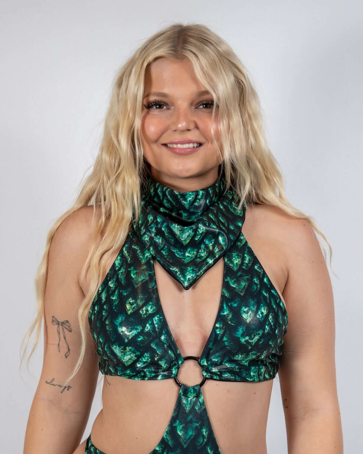 Model wearing a green-and-black scale print Predator Bandana, showcasing rave outfit vibes.