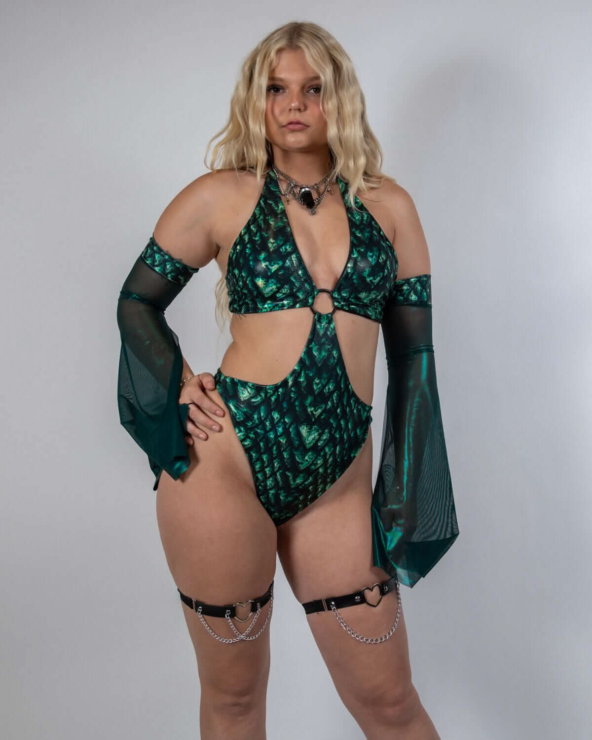 Model wearing emerald Predator Metamorphosis rave arm sleeves with flowing bell shape in festival outfit front view