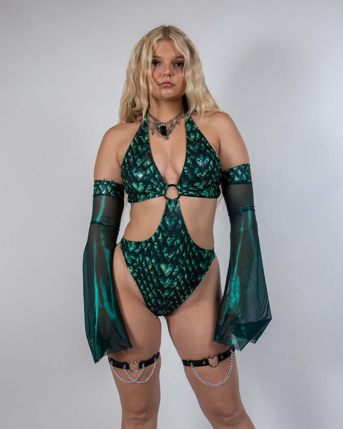 Model wearing green Predator Metamorphosis Sleeves paired with a matching rave outfit for dramatic, mystical flair.