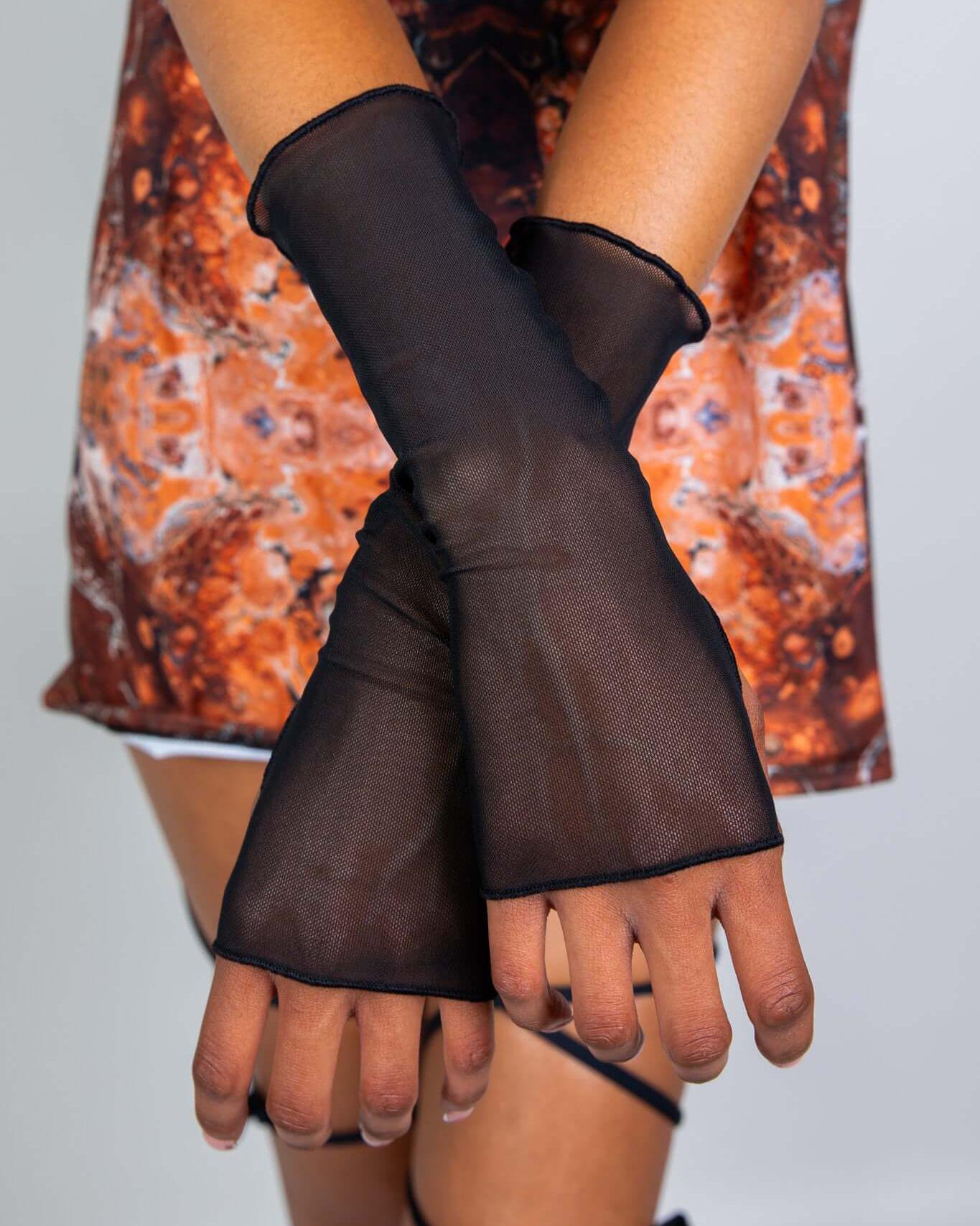 Black mesh gloves designed for rave outfits, featuring thumb holes and a stylish over-the-wrist design.