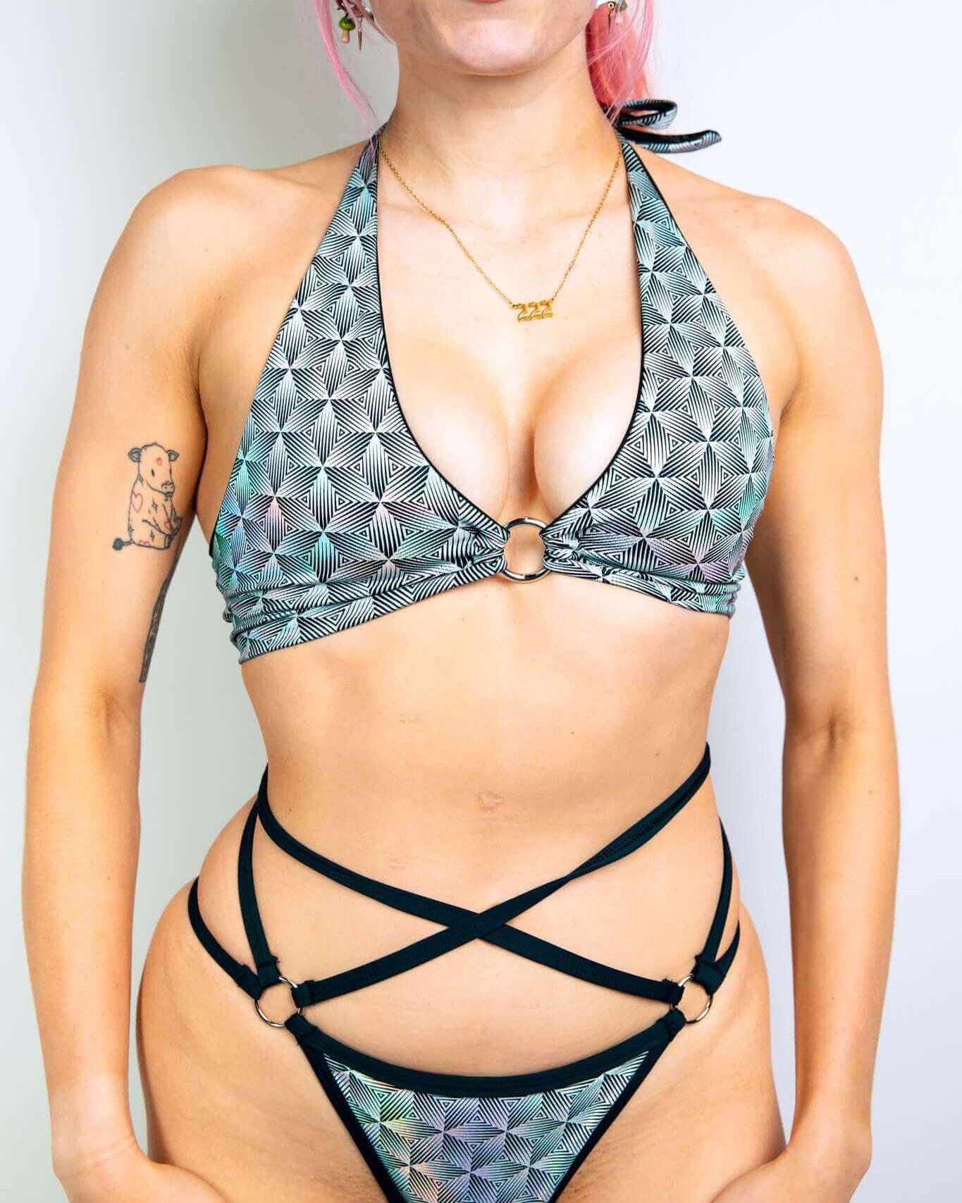 Model wearing the Prism O-Ring Halter Top, showcasing its unique holographic design and supportive fit, ideal for rave outfits.