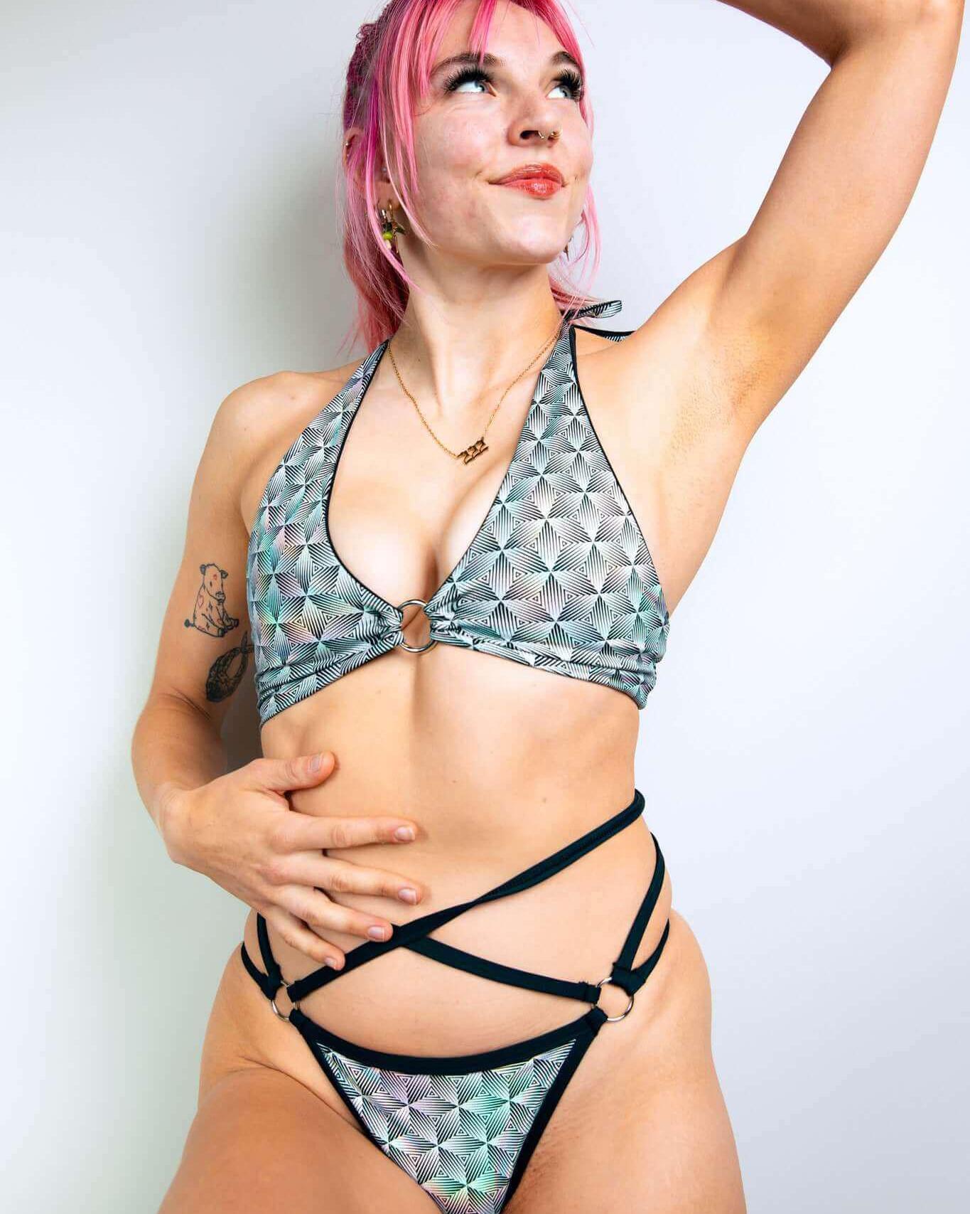 Model showcasing the Prism O-Ring Halter Top, a holographic rave outfit with a unique design and supportive fit.