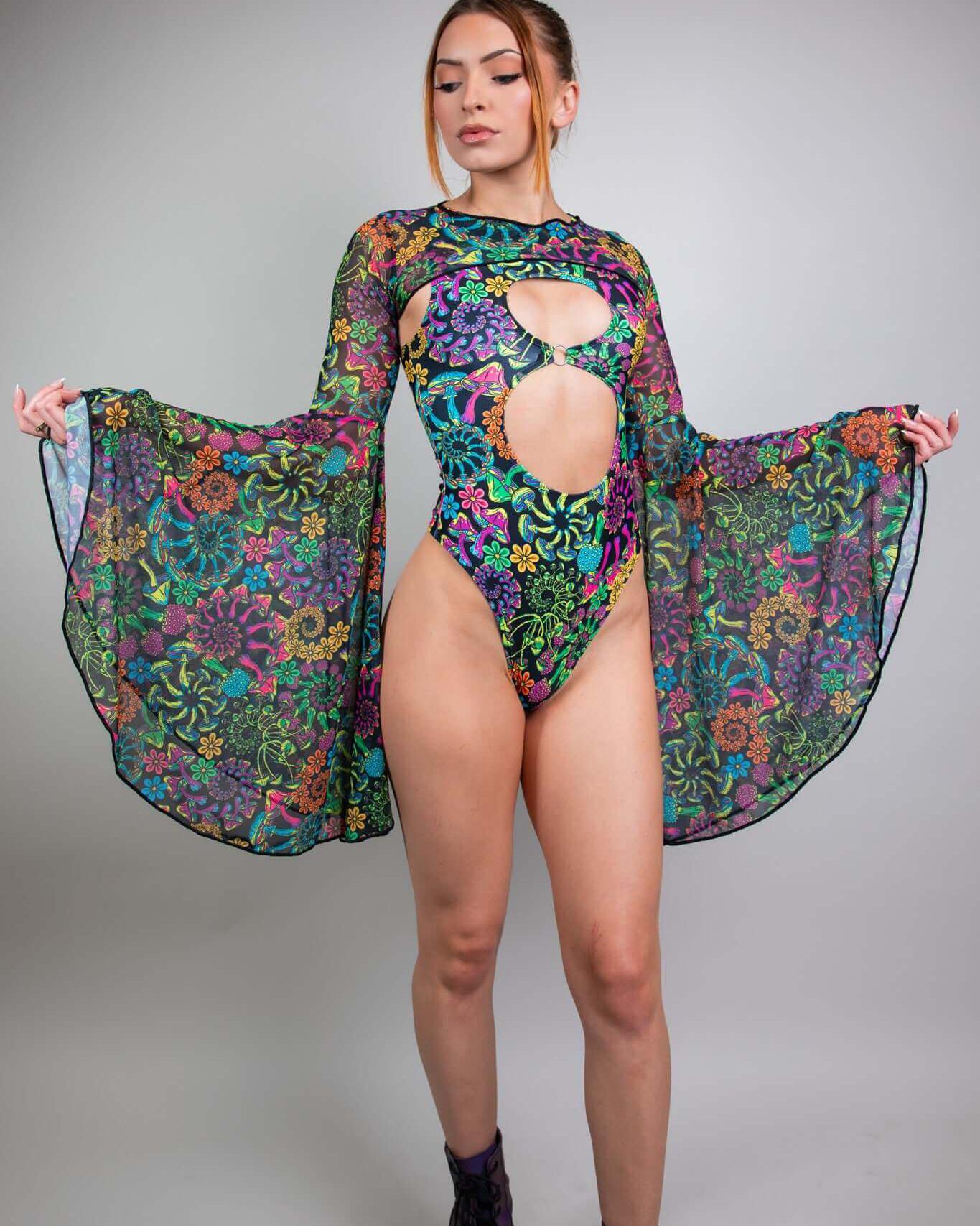 Model showcasing a vibrant floral bodysuit with dramatic bell sleeves, perfect for rave outfits.