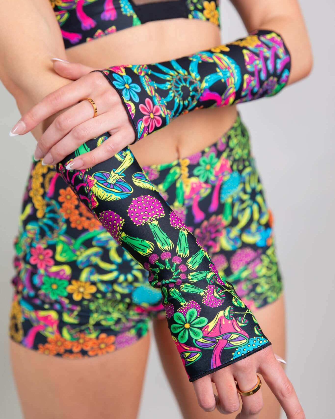 PsyBloom Gloves worn with a colorful rave outfit, featuring vibrant mushroom and floral patterns. Perfect for raves!