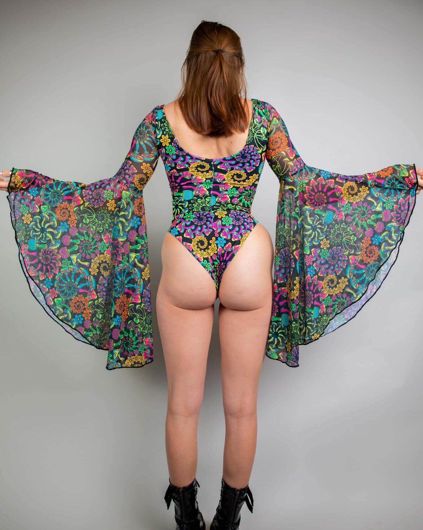 Model showcasing the PsyBloom Goddess Bodysuit with vibrant floral design and dramatic circle sleeves, perfect for rave outfits.