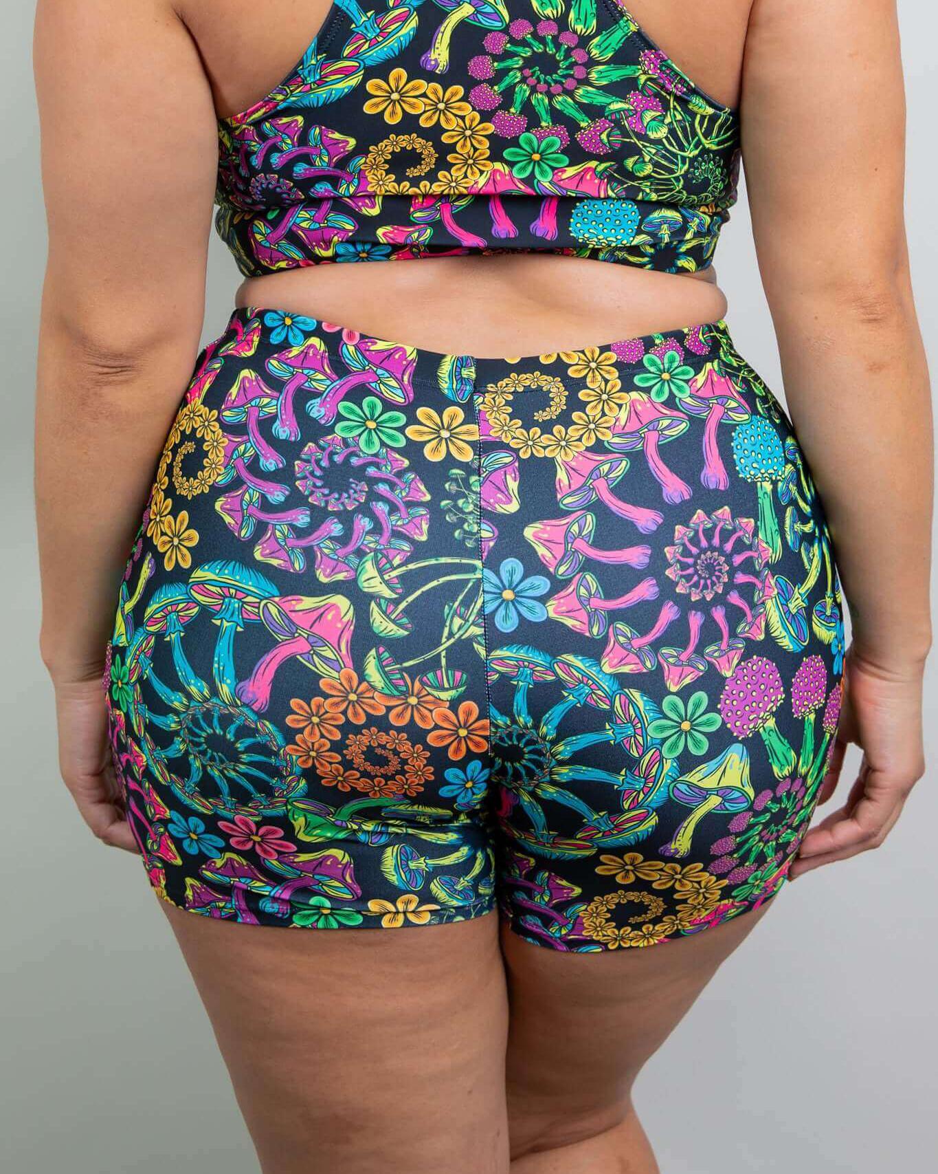 Brightly colored PsyBloom High Waist Shorts featuring a floral and mushroom pattern, perfect for rave outfits.