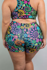 Model in Freedom Rave Wear featuring a vibrant V Free top and high-waisted rave shorts with intricate floral and psychedelic patterns