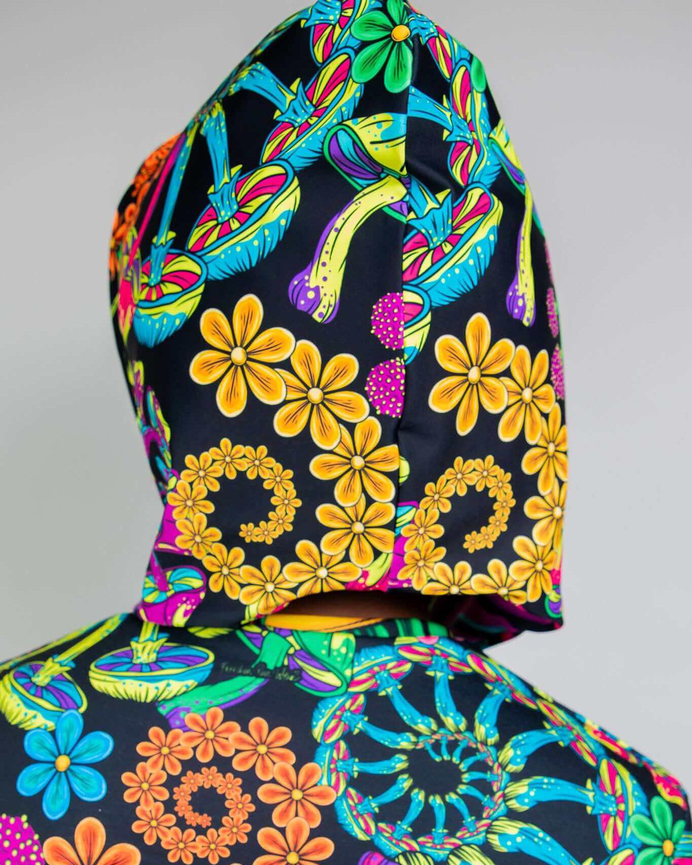 PsyBloom Assassin Hood featuring vibrant floral and mushroom patterns, perfect for rave outfits and festivals.