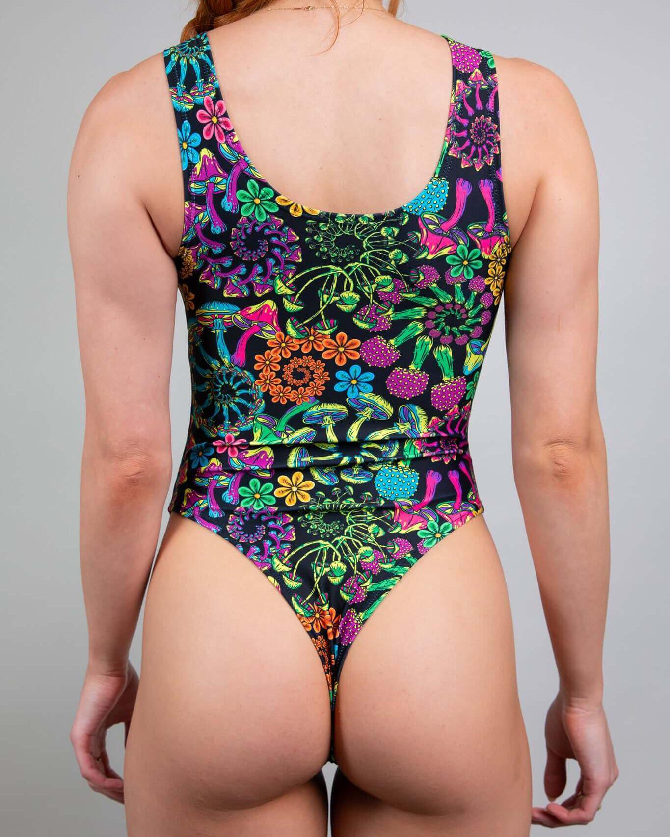 Back view of PsyBloom Keyhole Bodysuit featuring vibrant floral patterns, ideal for rave outfits and dancing.