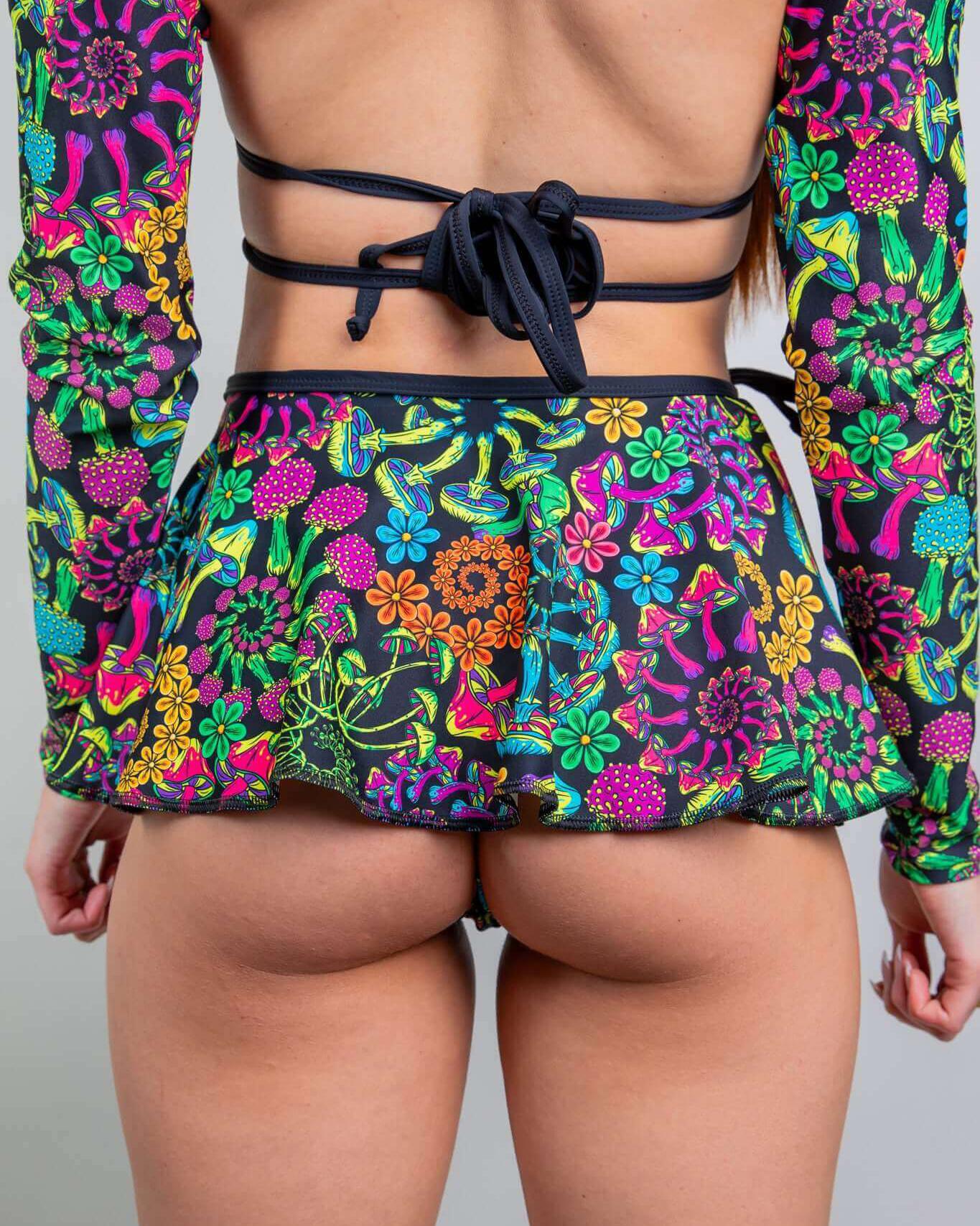 Model showcasing the colorful PsyBloom Swirl Skirt, perfect for rave outfits with a psychedelic floral design.